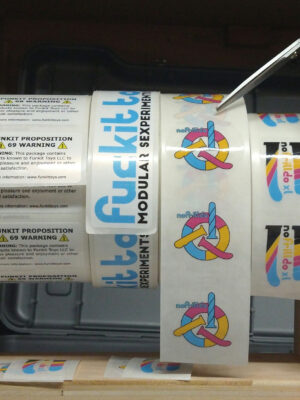 rolls of Funkit Toys stickers on a stand wit ha slot for a pair of scissors.